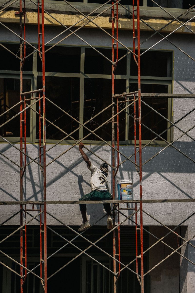 Painter on scaffolding at a building facade